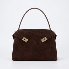 A luxurious dark brown suede handbag with a structured silhouette, featuring elegant gold-tone hardware clasps on the front, available at Bagratica.com.